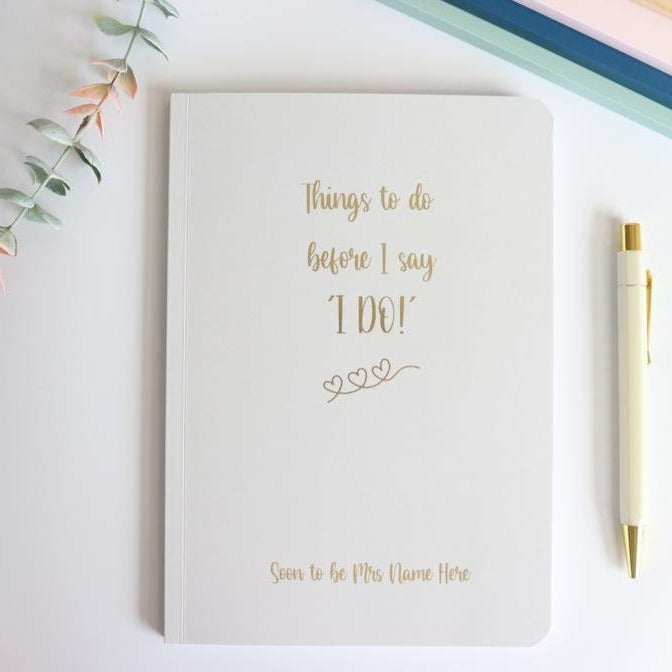 An A5 softback notebook in Pale Grey that says 'Things to do before I say I do, Soon to be Mrs Name Here' in gold foil