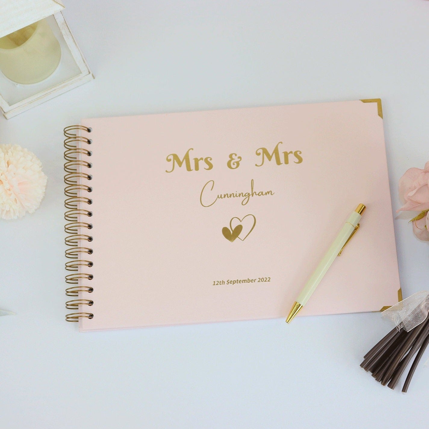 An A4 memory book in pale pink with the words 'Mrs and Mrs Cunningham' with a love heart image and a date underneath
