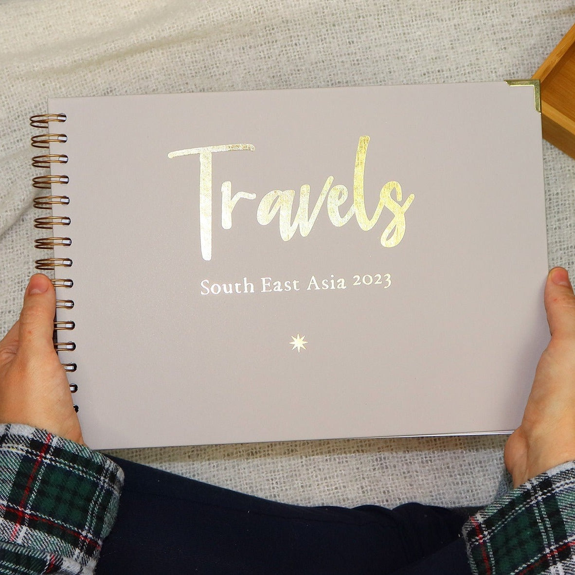 An A4 Memory book in Stone that says 'travels South east asia 2023' in gold foil