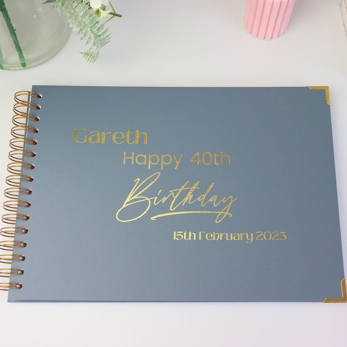 An A4 blue/grey memory book that says 'Gareth Happy 40th Birthday 15 February 2023' in gold foil