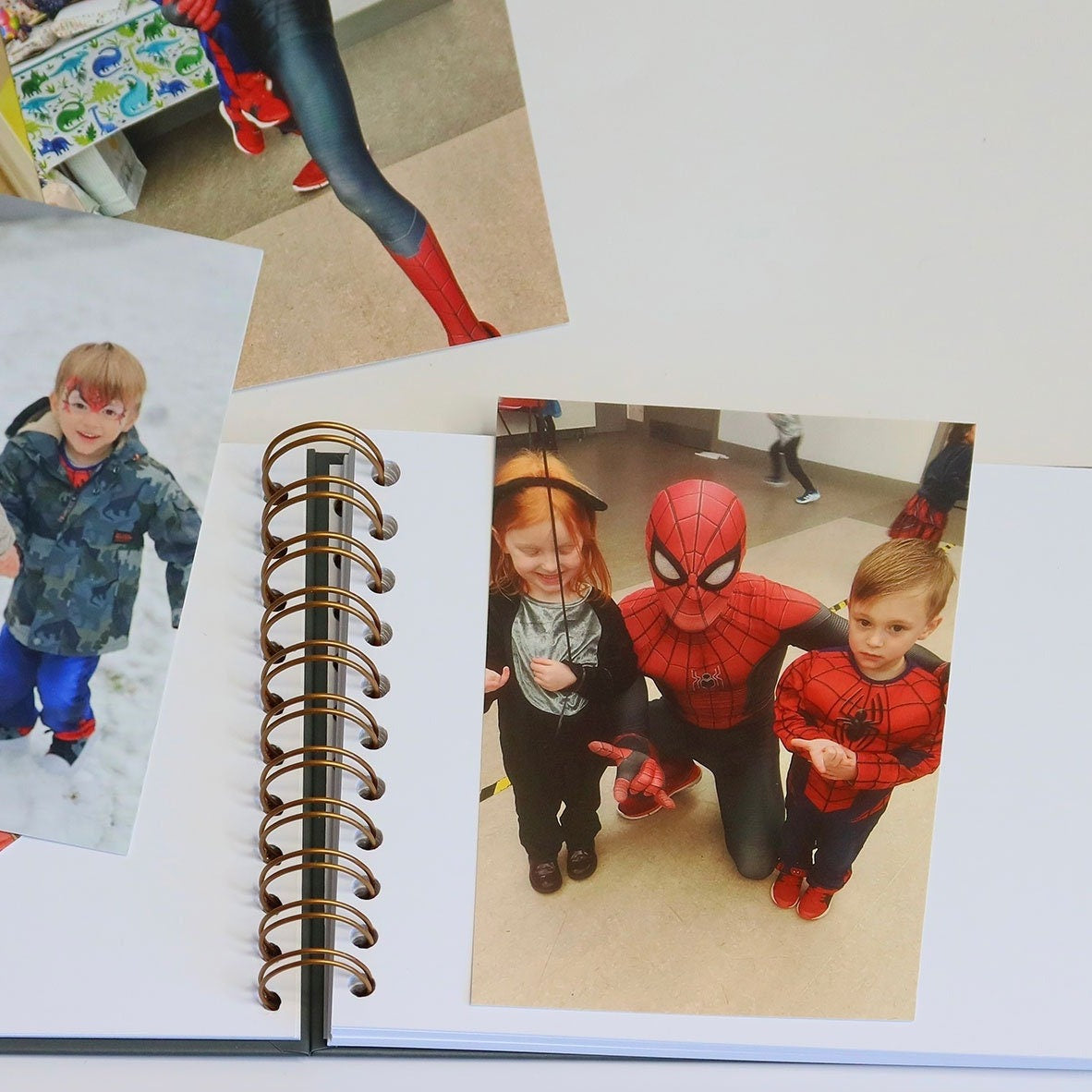 The inside pages of the A5 childrens memory book, There are pictures of a small boy with spiderman