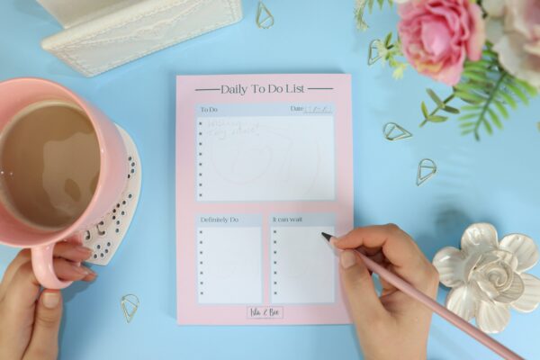 Daily 'To Do List' Desk Pad. An A5 portrait desk pad that reads 'Daily-to-do list' there are different sections, a 'to-do' list, a 'definitely do' list and a 'It can wait' list. The pad is pink and the sections are white.