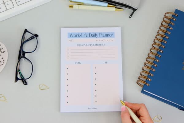 A5 Work/Life desk pad which has sections for daily work commitments and sections for daily life commitments, in pale blue and pale pink